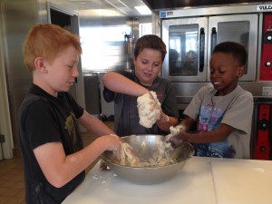 Dwyer, Alex and Jamaal are having a blast digging into the dough.