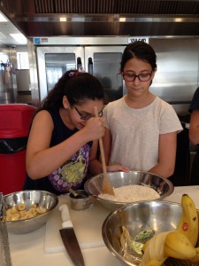 Sophia (left) and Olivia (right) carefully mix the banana pancake batter.