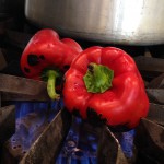 The ripe red peppers roast straight on the burner.