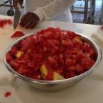 The chefs keep adding more to the big bowl of veggies.